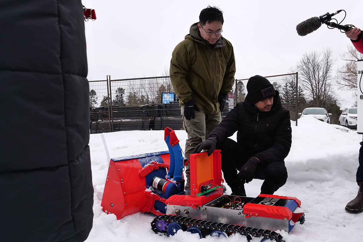A team of researchers and their robot creation.
