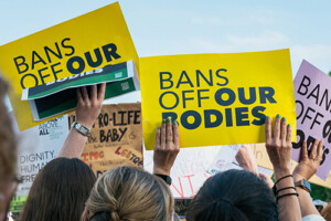 Protestors hold signs that read 'Bans Off Our Bodies'