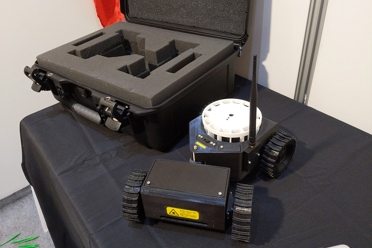 A robot and a case for the robot, on a table.