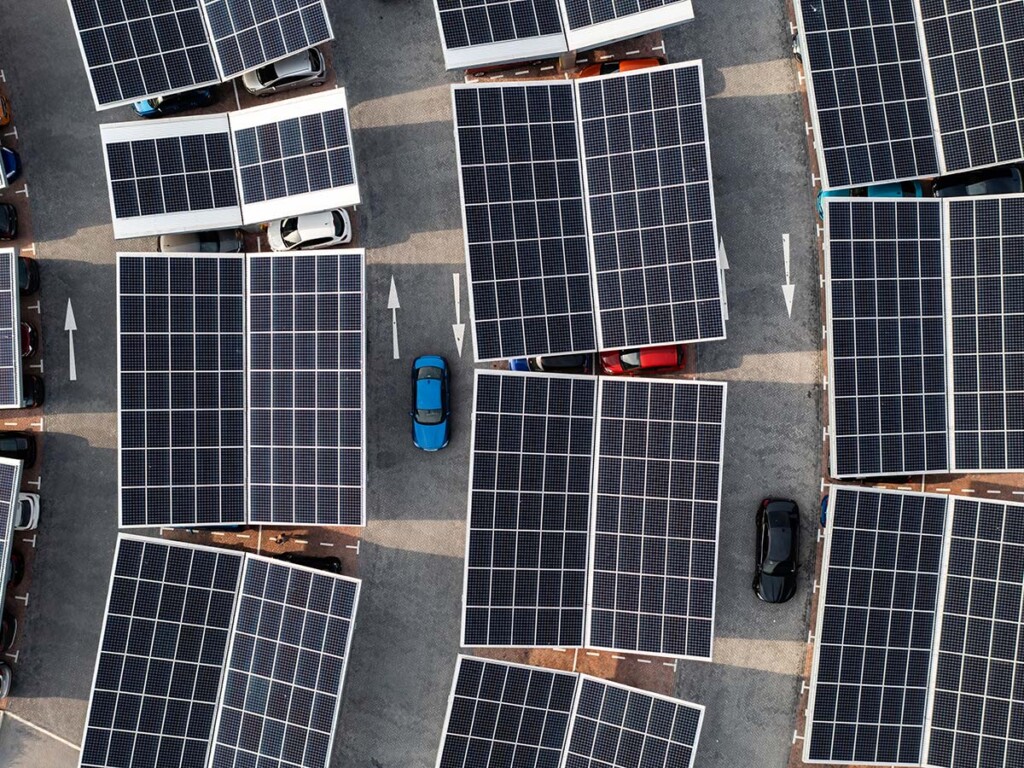 An aerial view of solar panels on parking lot roofs in France