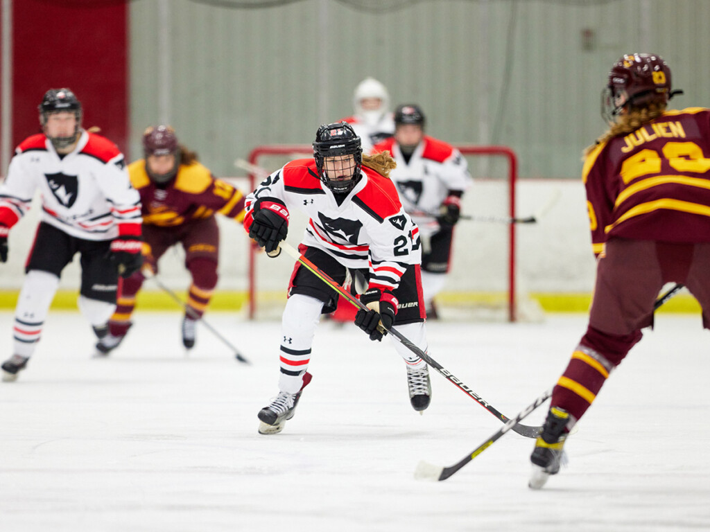 A hockey game captured mid-game, captured to showcase how Ravens women soar in athletics