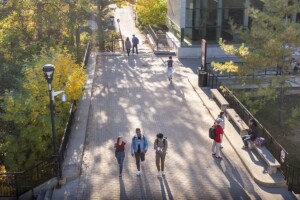 An aerial view of five people walking through the Carleton University quad