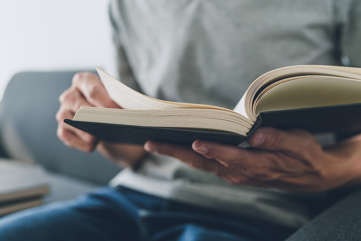 Hands reading a book.