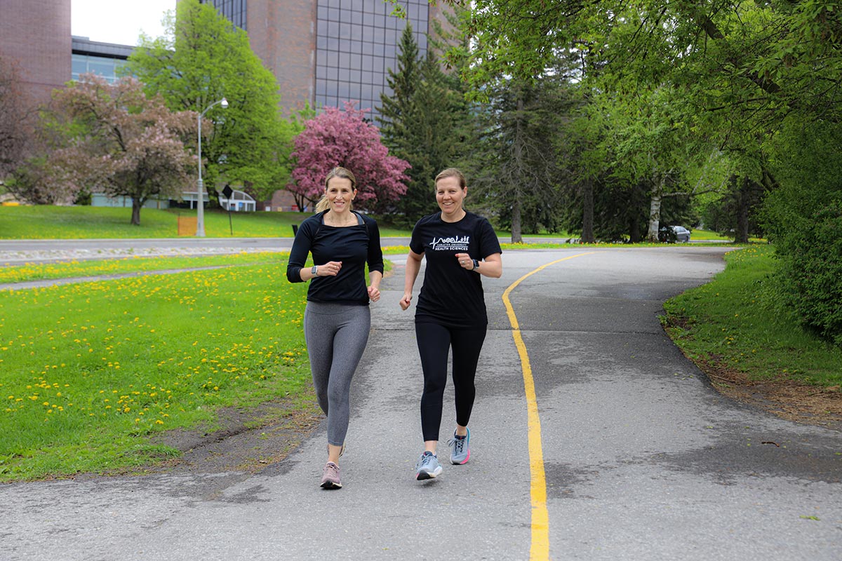 Two women running on a path