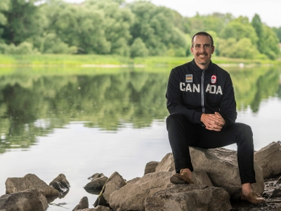 Tom Hall sits next to the Rideau River