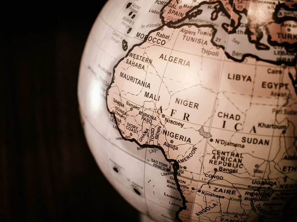 The African continent can be seen on a light brown globe