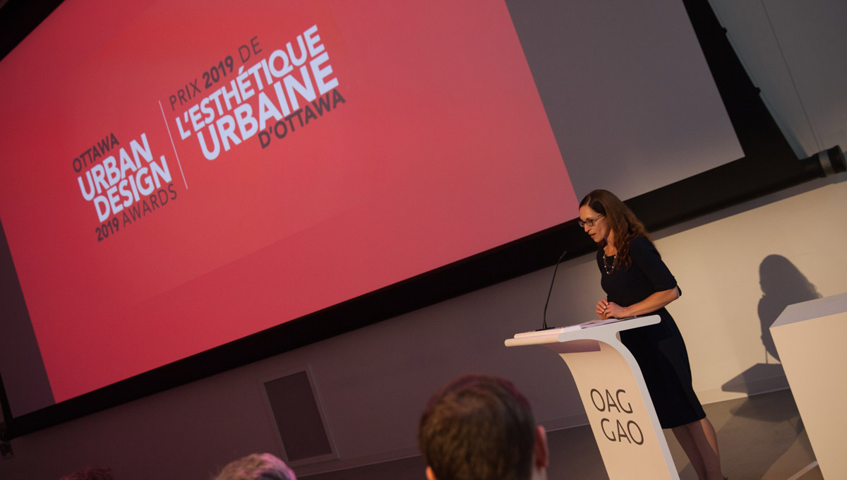 A speaker presents at a podium during the Urban Design Awards