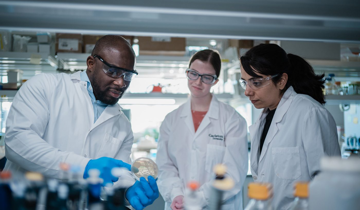 Three scientists working in a lab.