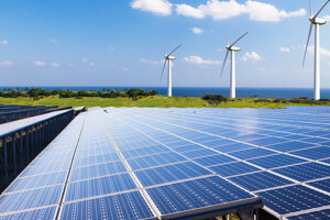 Wind turbines and solar panels along a coastline
