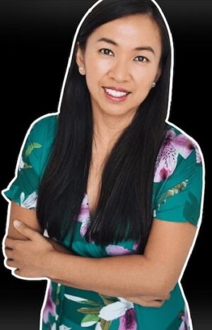 Cherry Chan, a women, crosses her arms and smiles at the camera.