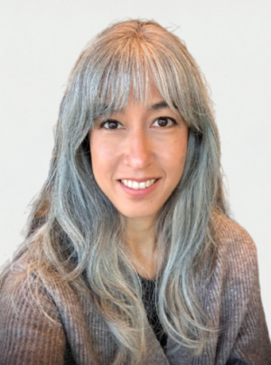 A woman, Jodene, smiles at the camera.
