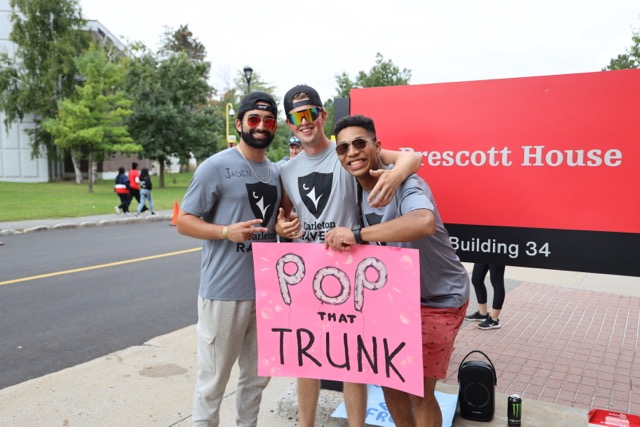 Students during Residence Move-In holding a sign that reads 