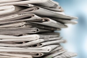 Pile of newspapers on white background