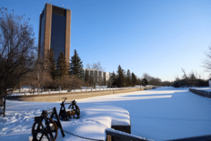 The Rideau Canal during a sunny winter day, with Dunton Tower in the background.
