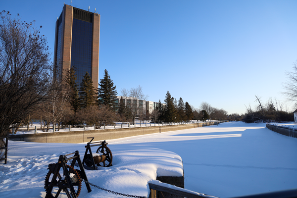 The Rideau Canal during a sunny winter day, with Dunton Tower in the background.