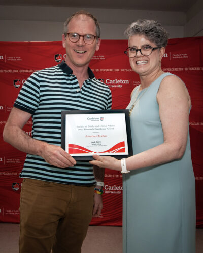 photo of Jon Malloy receiving award from Dean Brenda O'Neill