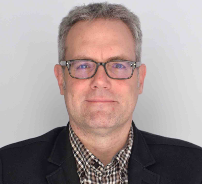 Portrait of Man with Black Suit, Grey Hair and Glasses