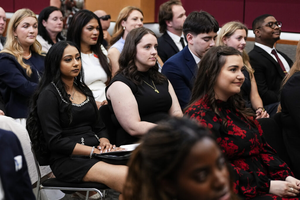 graduates listening to remarks from the audience