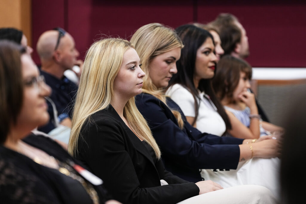 graduates listening to remarks from the audience
