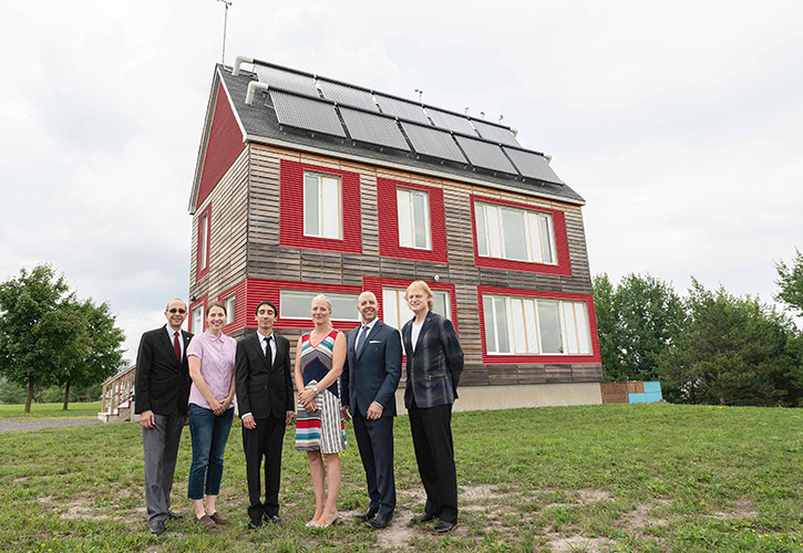 Environment and Climate Change Minister Catherine McKenna (third from right) and Carleton faculty and students, including President Benoit-Antoine Bacon, Vice-President (Research and International) Rafik Goubran and Prof. Ian Beausoleil-Morrison, outside the Urbandale Centre for Home Energy Research