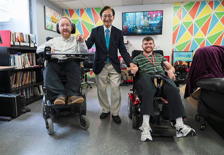 Ontario Minister of Seniors and Accessibility Raymond Cho with a pair of Paul Menton Centre for Students with Disabilities clients