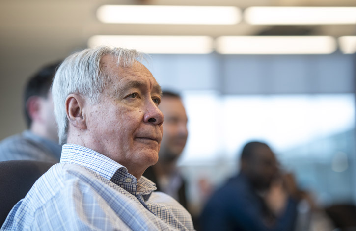 A headshot of Tony Bailetti siting in a conference room listening to a lecture