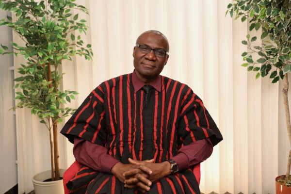 Carleton University president Wisdom Tettey poses for the camera while seated.
