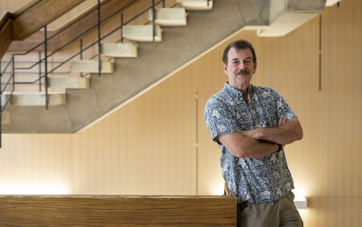 Tim Patterson crosses his arm and poses for the camera in a starway in Steacie Building.