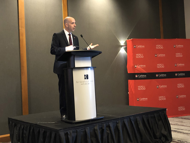 President Benoit-Antoine Bacon speaks at a podium during the Leadership Luncheon at the Brookstreet Hotel