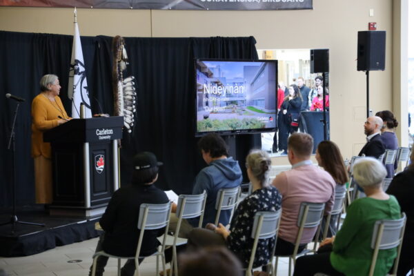 Barbara Dumont-Hill speaks to a crowd of people
