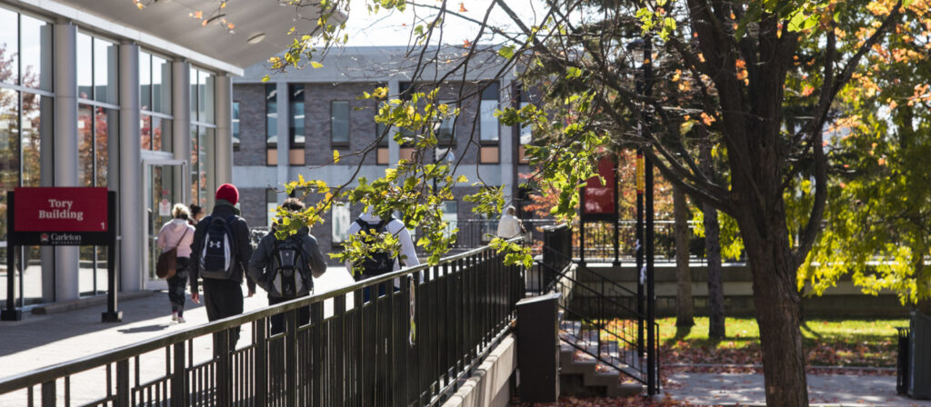 Student walking by Tory building