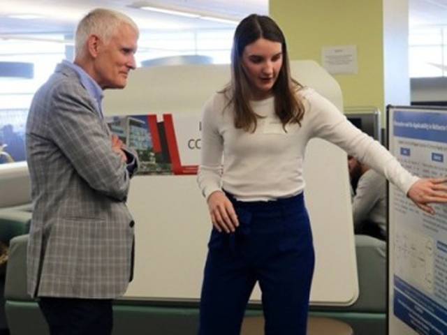 Commerce student Gemma Rod presents the research she completed at the I-CUREUS Conference to Provost Jerry Tomberlin