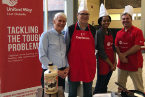 Carleton senior leaders serve pancakes at the Provost's Pancake Breakfast in support of United Way