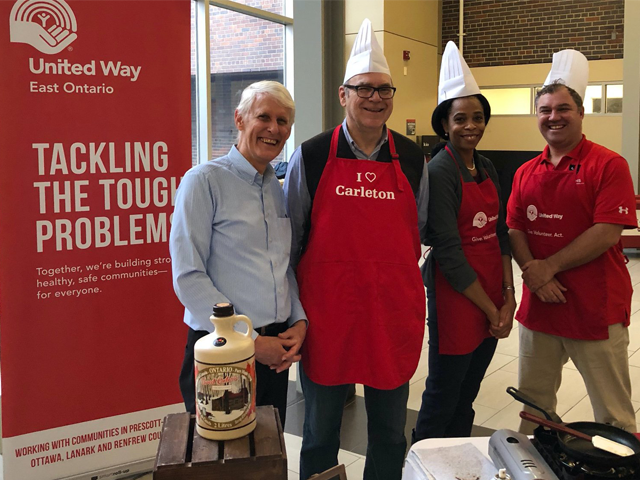 Carleton senior leaders serve pancakes at the Provost's Pancake Breakfast in support of United Way