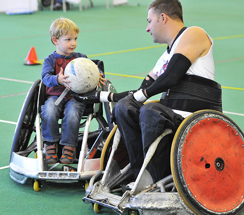 young boy trying wheelchair rugby
