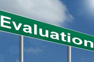 Green road sign with the word Evaluation written in white.