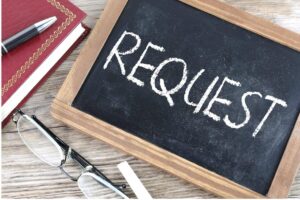 Image of a black chalkboard with the word request written in white chalk 