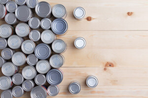Cans sitting on a table, as viewed from their top side