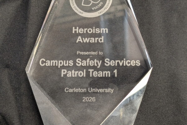Glass trophy with writing. OACUSA Heroism Award