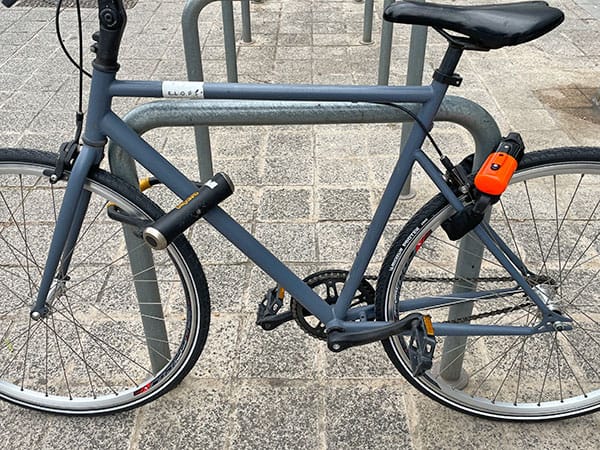 Bike properly secured to a bike rack using a u-lock.