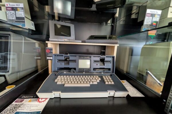 Photo of vintage computing in display case (Osborne 1, Apple IIe, Super PET)