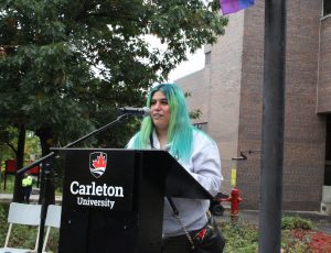 Pride Festival Leader providing opening remarks at a podium.
