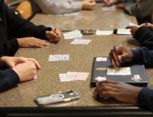 Close up of students bingo cards as they are being filled out during the game.