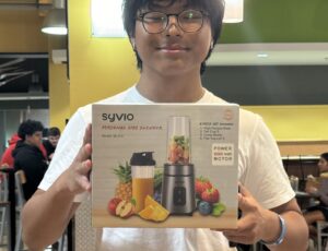 Student displaying their bingo prize: Personal Blender.