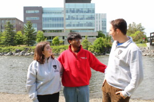 Three students conversing outside.