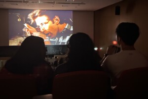 Students watching a movie on the big screen.
