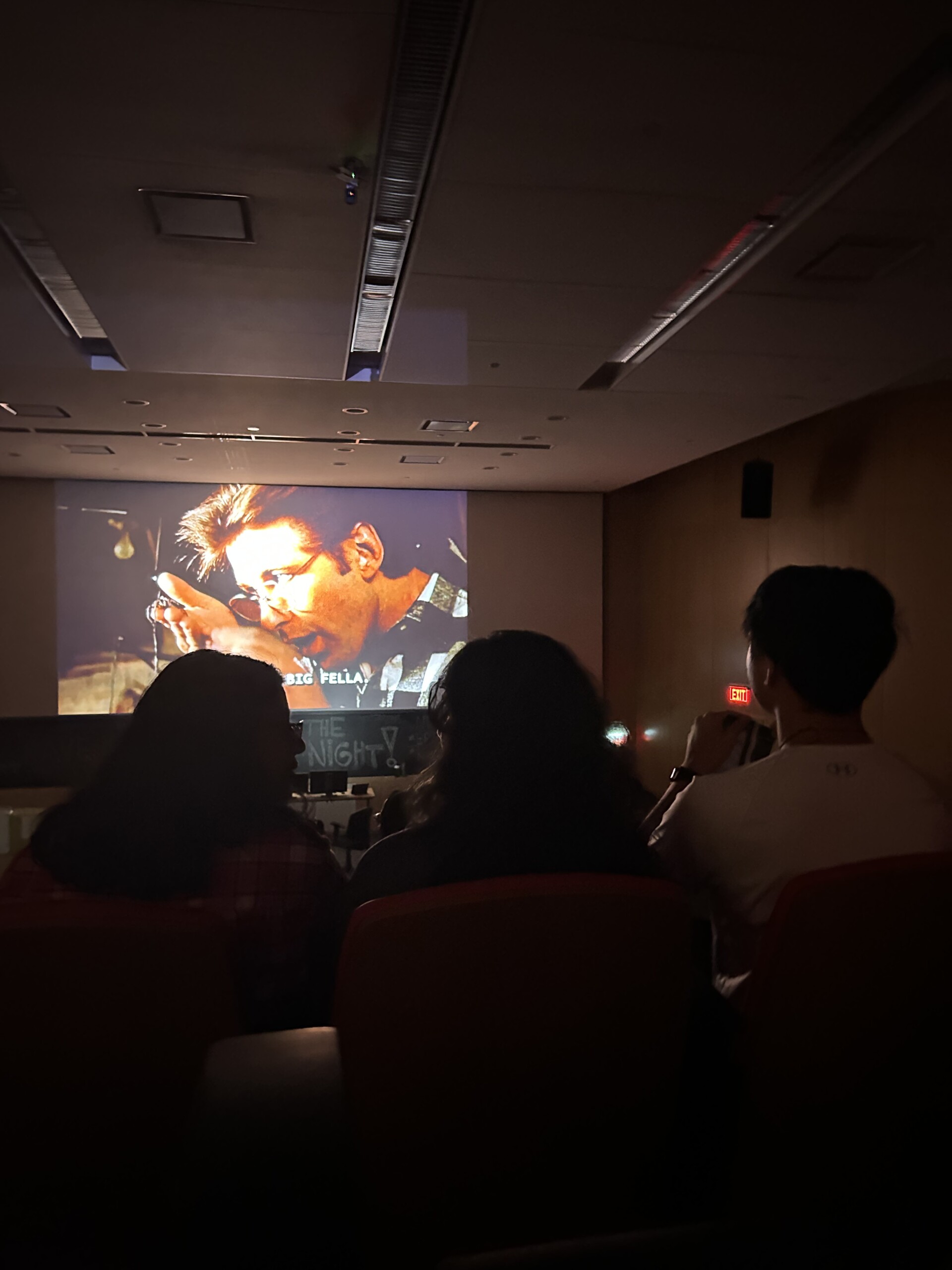 Students watching a movie on the big screen.