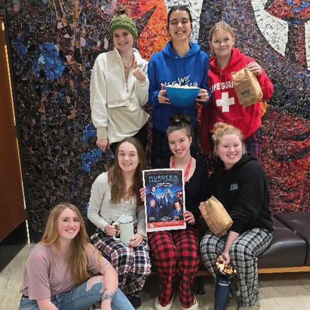 Group of students showing off their movie poster.