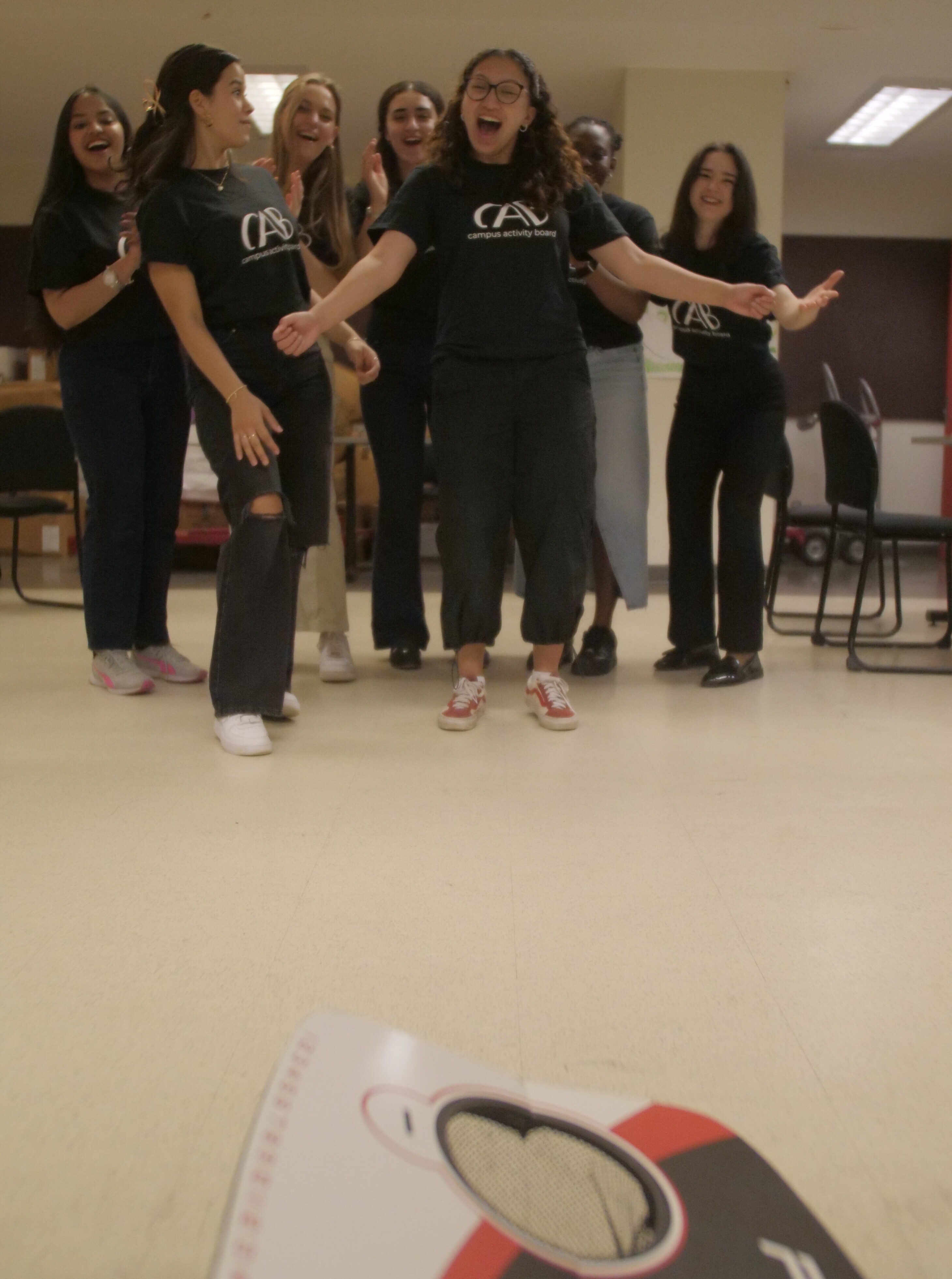 Students playing bean bag toss.