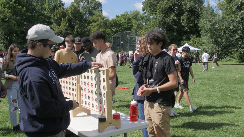 students playing a large connect four game